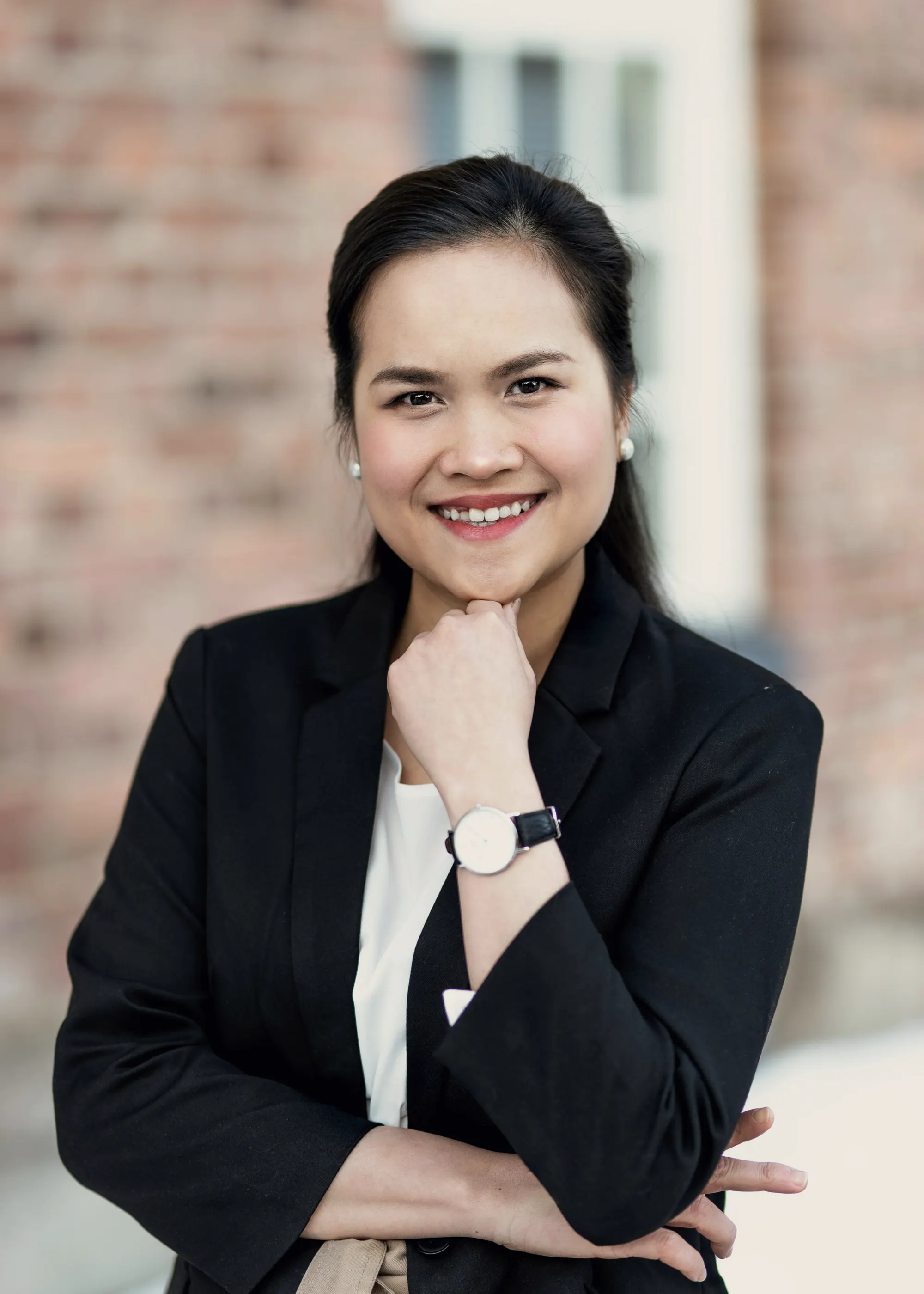 Business owner leaning against an office wall